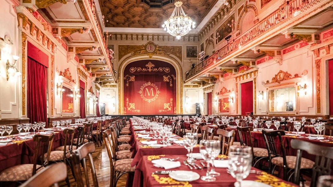 Elegant dining hall set for Mansión Tango Show in Buenos Aires.