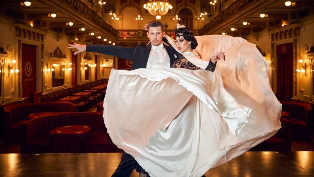 Dancers performing at Mansión Tango Show in an elegant ballroom setting.