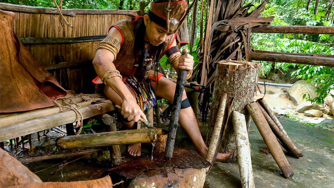 Man demonstrating traditional craft at Mari Mari Cultural Village tour.
