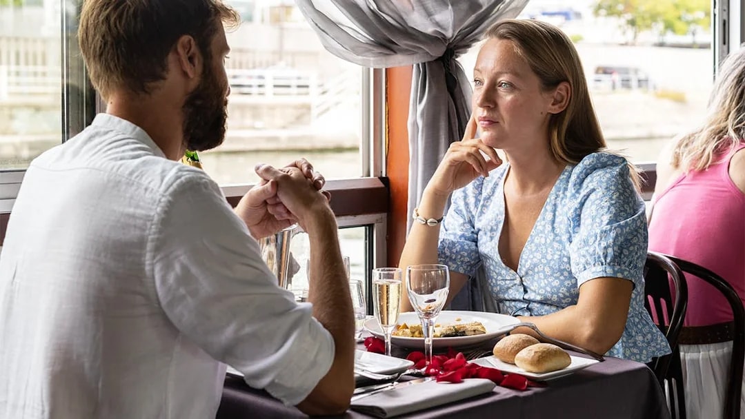 Couple dining on La Marina Orsay Lunch Cruise in Paris.