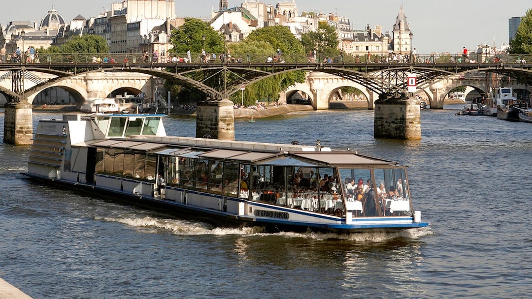 Lunch cruise boat on the Seine River near Pont des Arts, Paris.