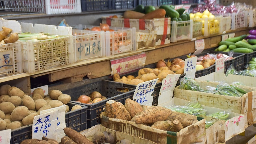 Market stall with fresh vegetables and root crops for Market to Table Culinary Tour.