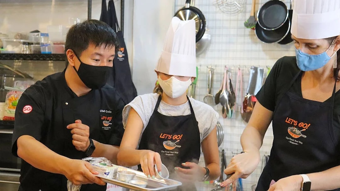 Chef guiding participants in a cooking class during a Market to Table Culinary Tour.