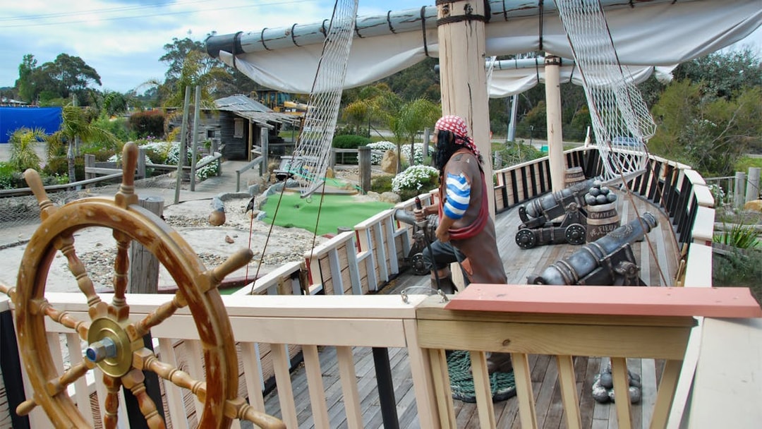 Pirate ship exhibit at Maru Koala and Animal Park, featuring cannons and a ship's wheel.