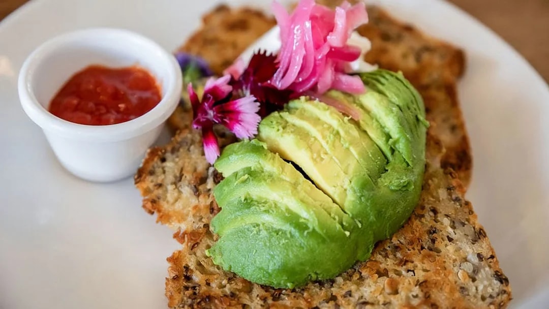Avocado toast with pickled onions and flowers, served with a side of salsa on the Mary Valley Rattler Train.