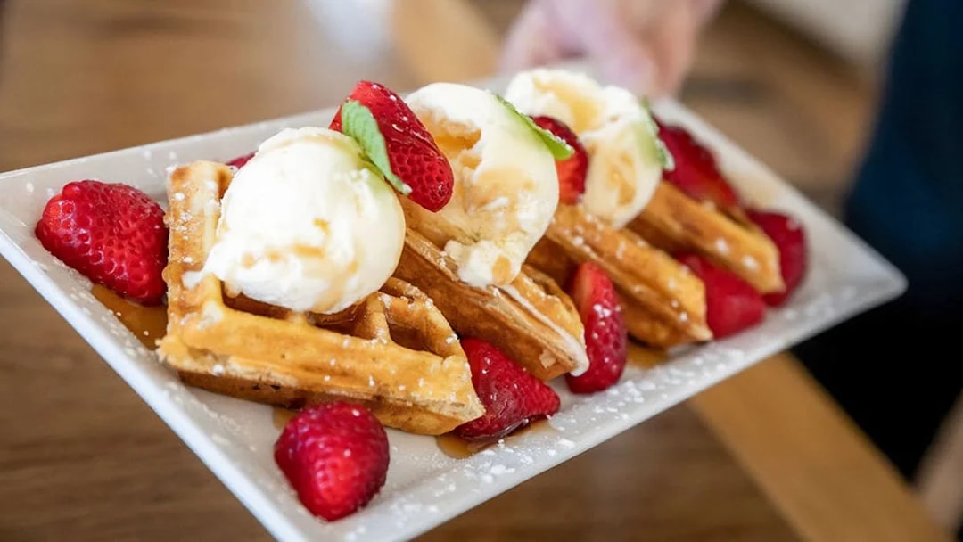 Waffles with ice cream and strawberries served on the Mary Valley Rattler Train Experience.