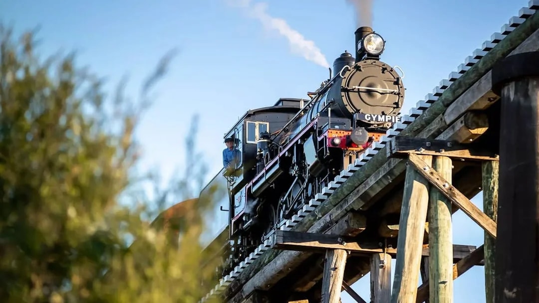 Mary Valley Rattler steam train crossing a wooden bridge near Gympie.