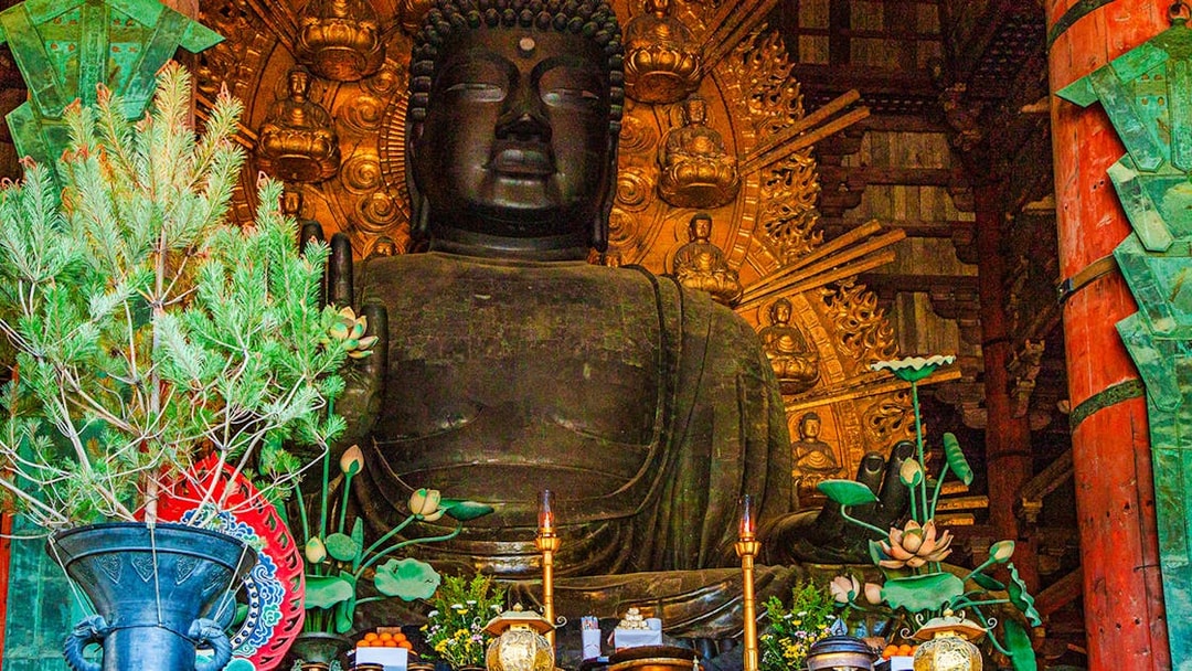 Buddha statue with offerings inside Tōdai-ji Temple, Nara, Japan.