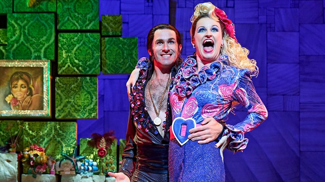 Performers in colorful costumes on stage during Matilda The Musical.