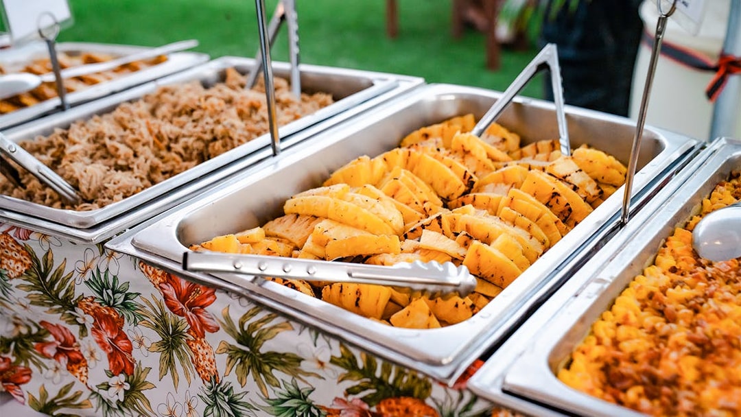 Buffet with grilled pineapple and pulled pork at Mauka Warriors Luau.