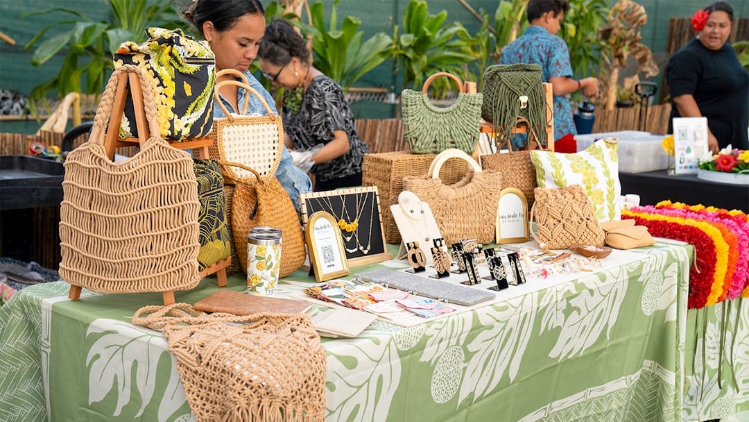 Handcrafted jewelry and bags displayed at Mauka Warriors Luau marketplace.