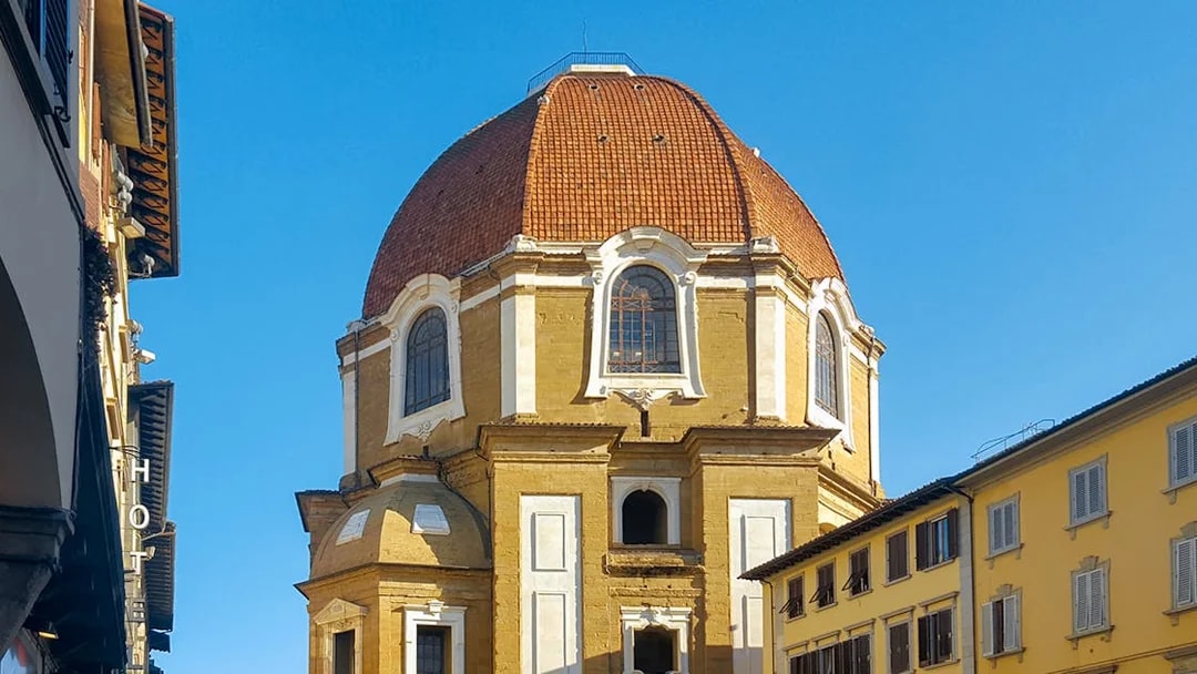 Cappelle Medicee dome and exterior in Florence, Italy, with surrounding buildings.