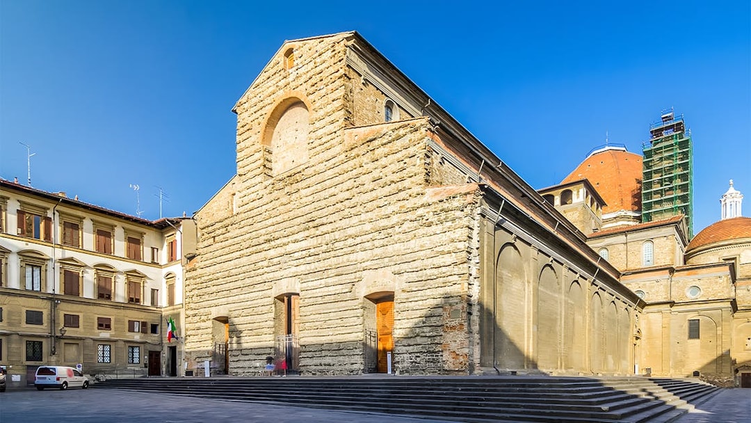 San Lorenzo Church exterior in Florence, Italy, showcasing its stone facade and architectural details.