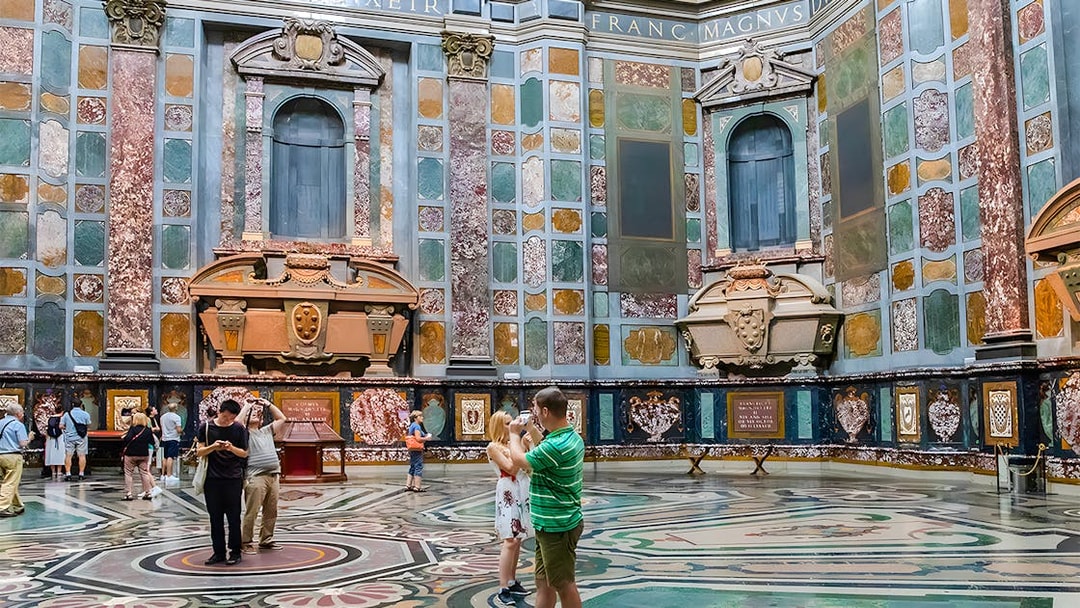 Visitors exploring the ornate interior of the Medici Chapels in Florence, Italy.