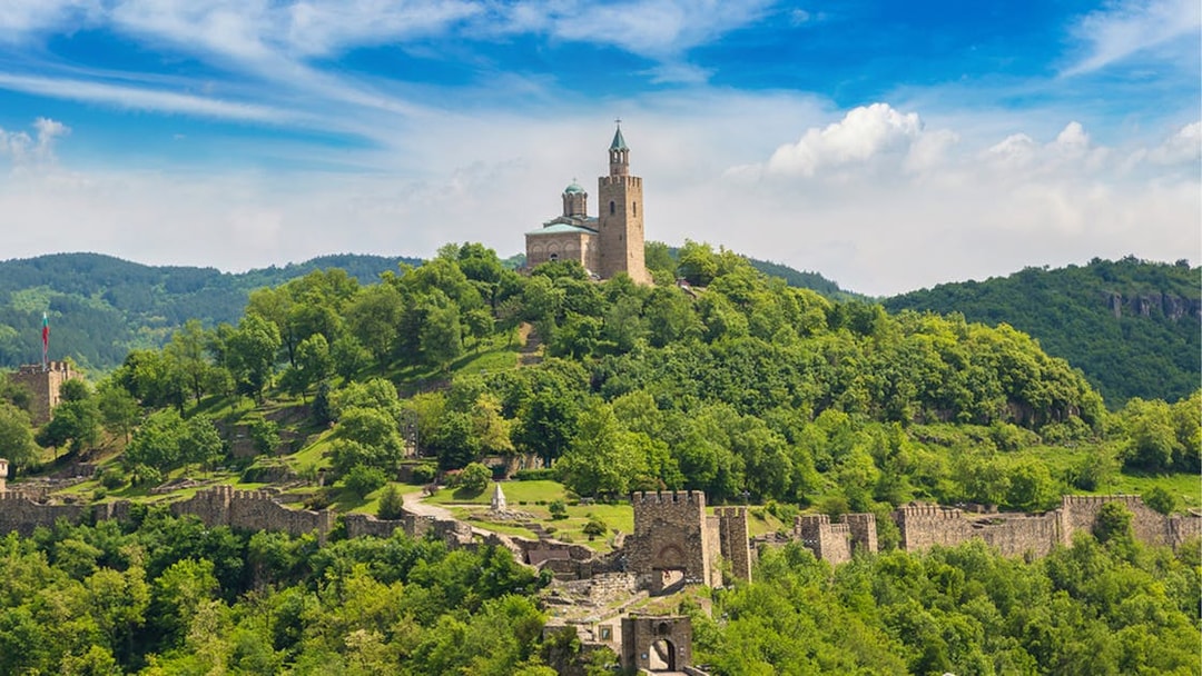 Tsarevets Fortress on a hill surrounded by lush greenery in Veliko Tarnovo, Bulgaria.