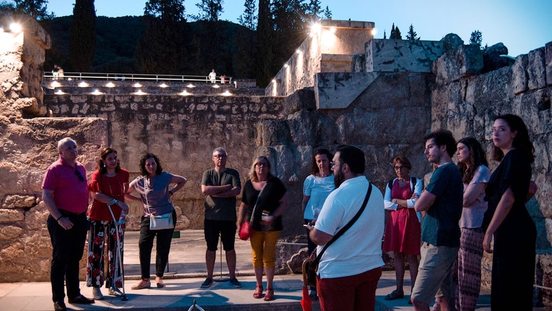 Group of tourists on a guided night tour at Medina Azahara, Córdoba.