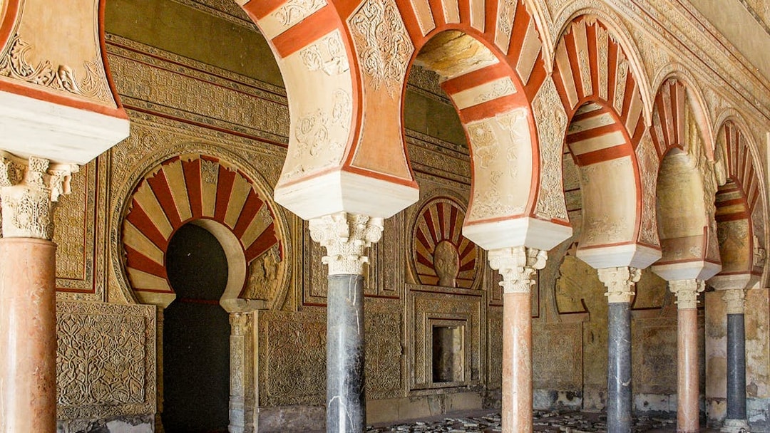 Arched pillars and intricate carvings at Medina Azahara archaeological site in Córdoba, Spain.