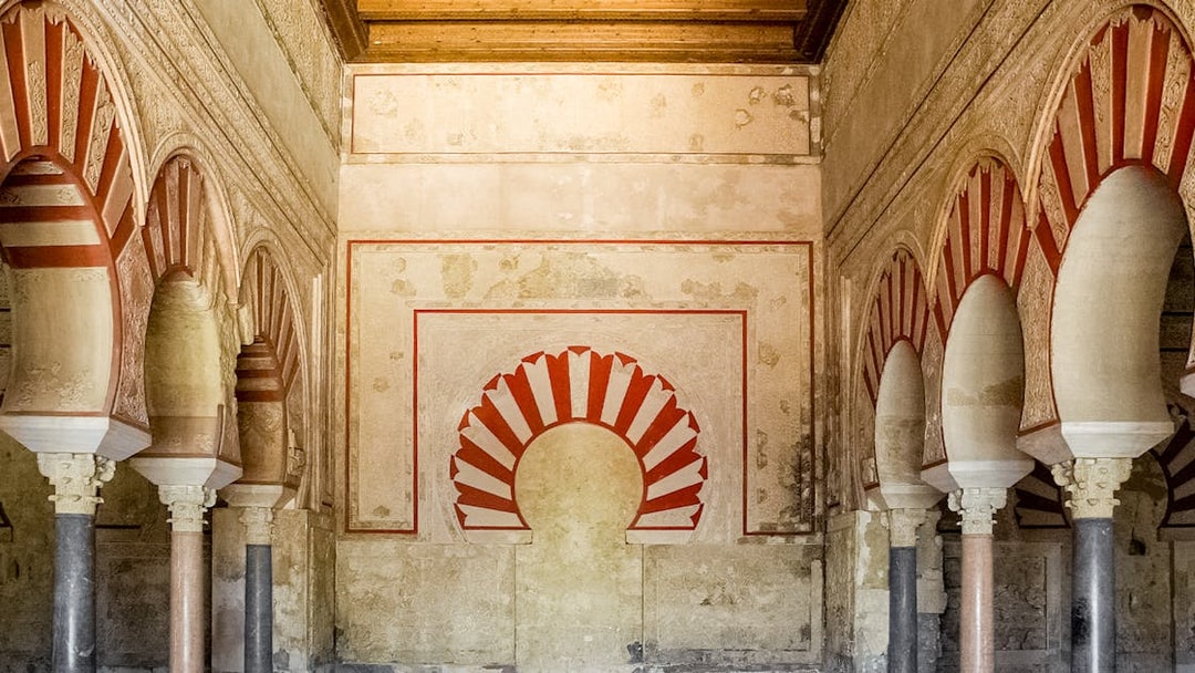 Interior arches and detailed wall design of Medina Azahara archaeological site.
