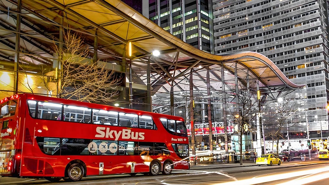 Skybus Melbourne Airport Shuttle at night in city center.