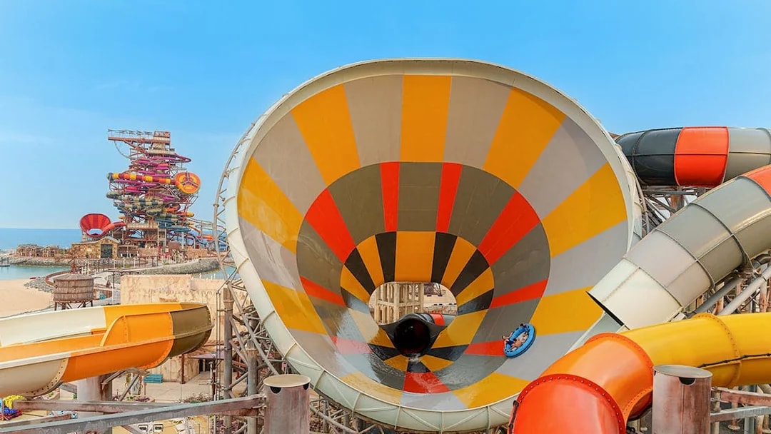 Visitors on a colorful water slide at Meryal Waterpark.