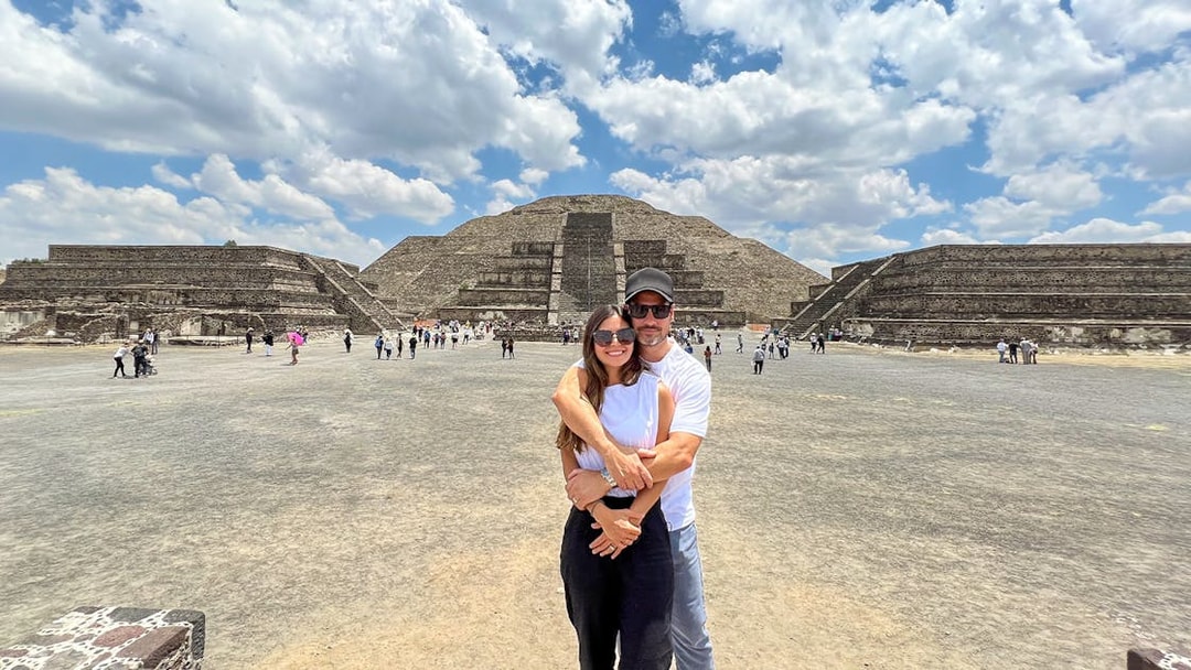 Tourists at Avenue of the Dead, Teotihuacan, with Pyramid of the Moon in the background.