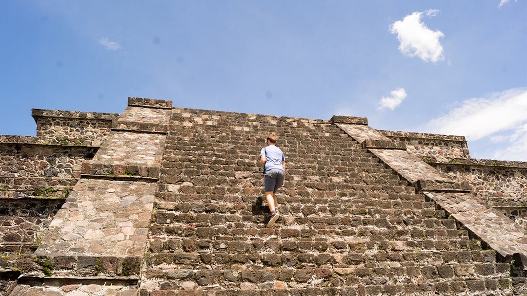 Tourist climbing the Pyramid of the Moon in Teotihuacan, Mexico.