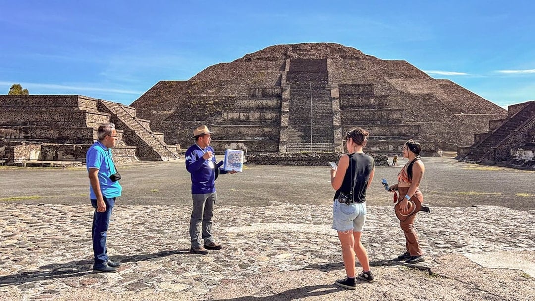 Tour group with guide at Pyramid of the Moon, Teotihuacan, Mexico.