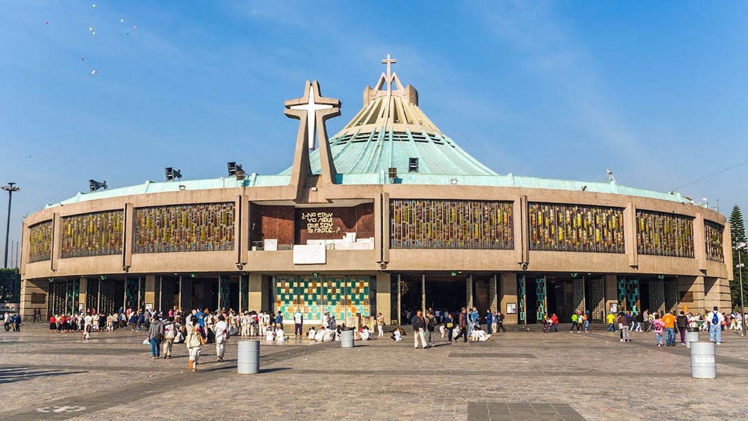 Basilica of Guadalupe exterior with visitors in Mexico City.