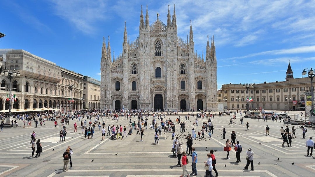 Guided tour group exploring Milan Cathedral facade.