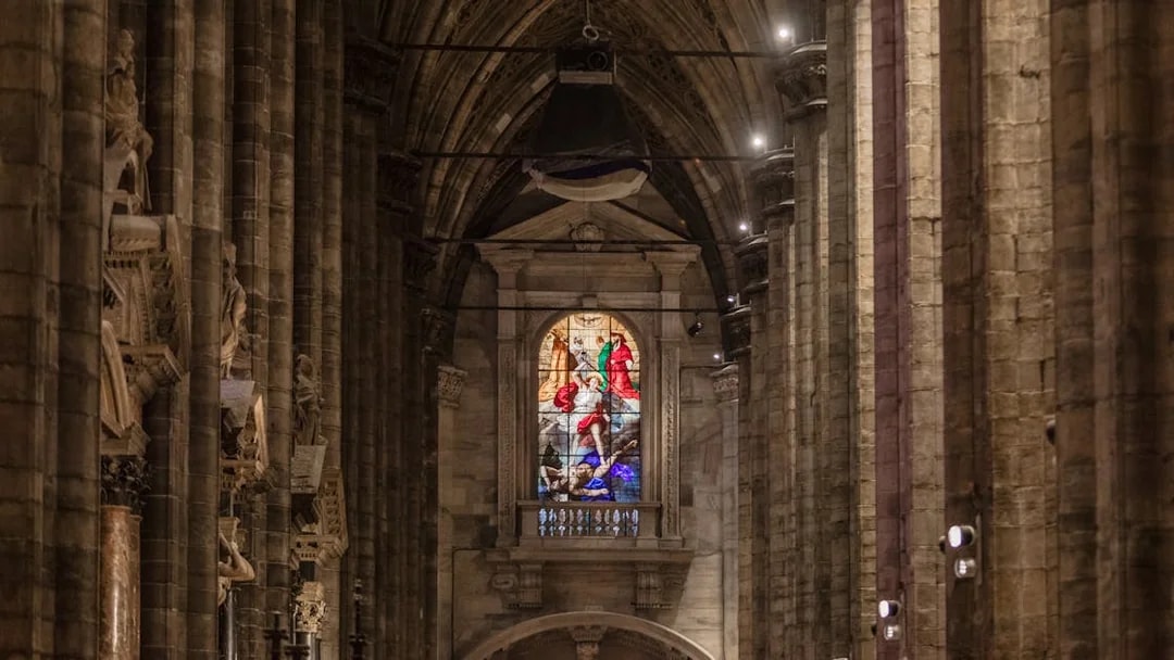 Stained glass window inside Milan Duomo Cathedral, Italy.