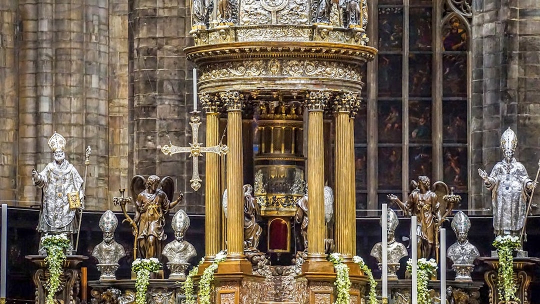 Duomo Milan Cathedral interior with ornate altar and religious statues.