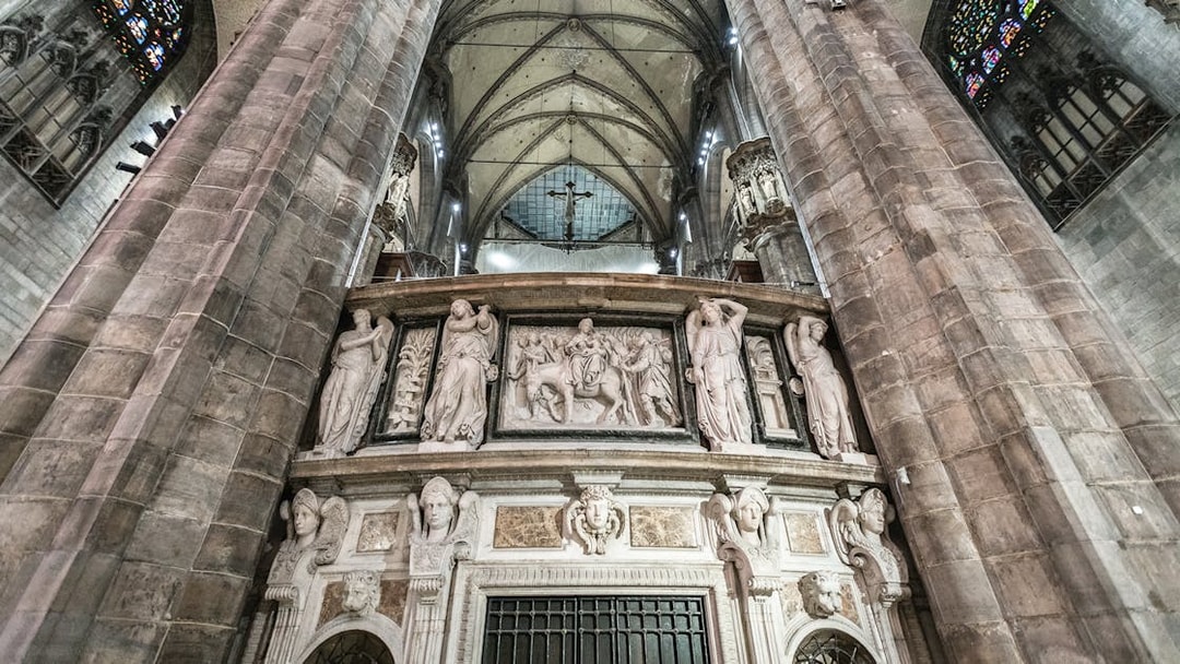 Duomo Milan Cathedral interior with ornate sculptures and vaulted ceiling.