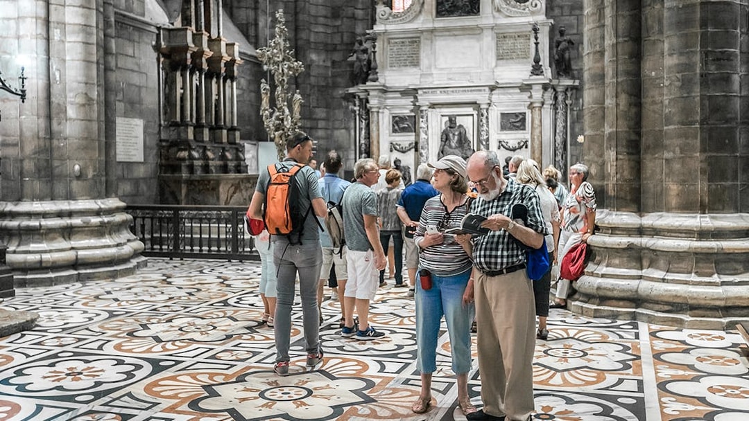 Tourists exploring the interior of Duomo Cathedral, Milan.