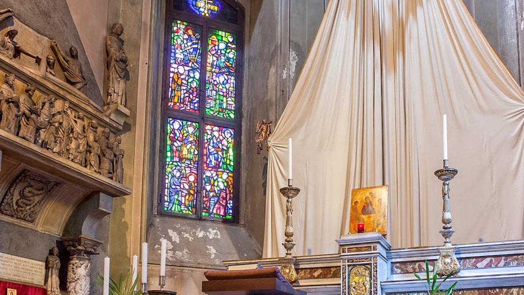 Stained glass window and altar inside Church of St. Gottard, Milan.