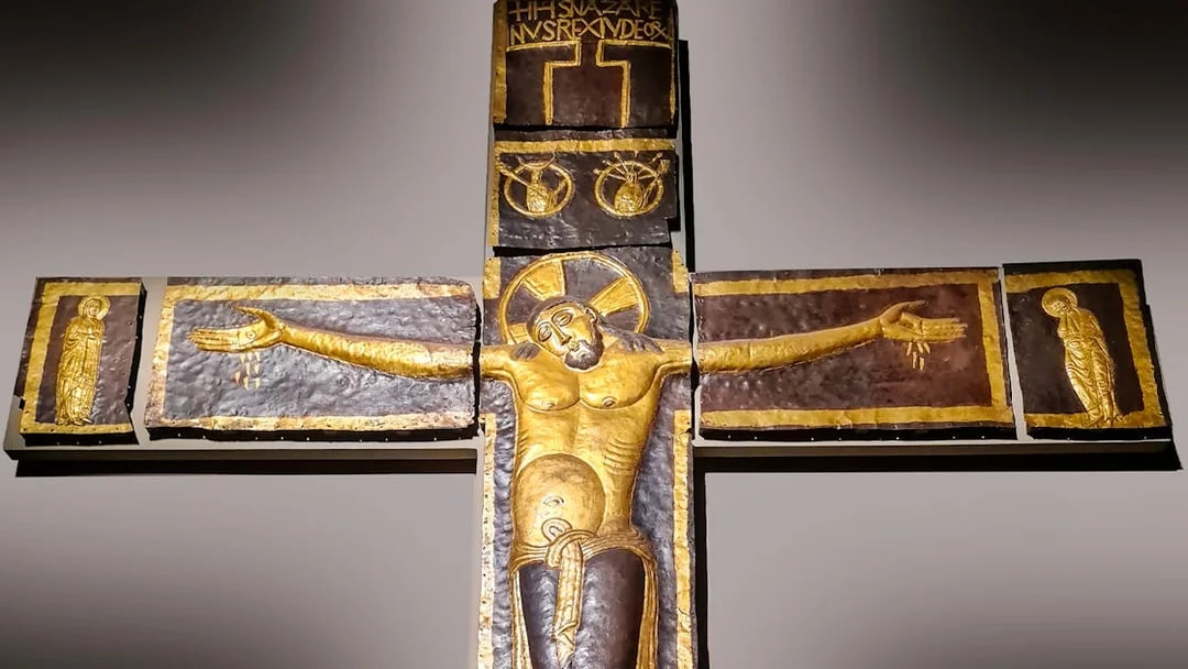 Processional Cross at Milan Duomo Museum depicting Christ with outstretched arms.