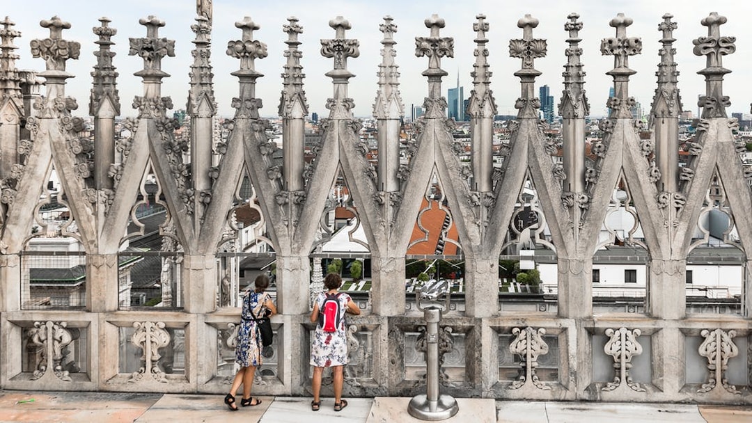 Visitors enjoying the view from the rooftop of Milan Duomo Cathedral.