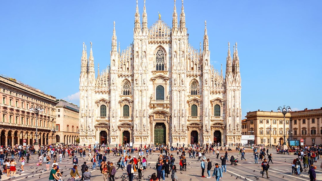 Duomo di Milano Cathedral exterior with visitors in the square, Milan, Italy.
