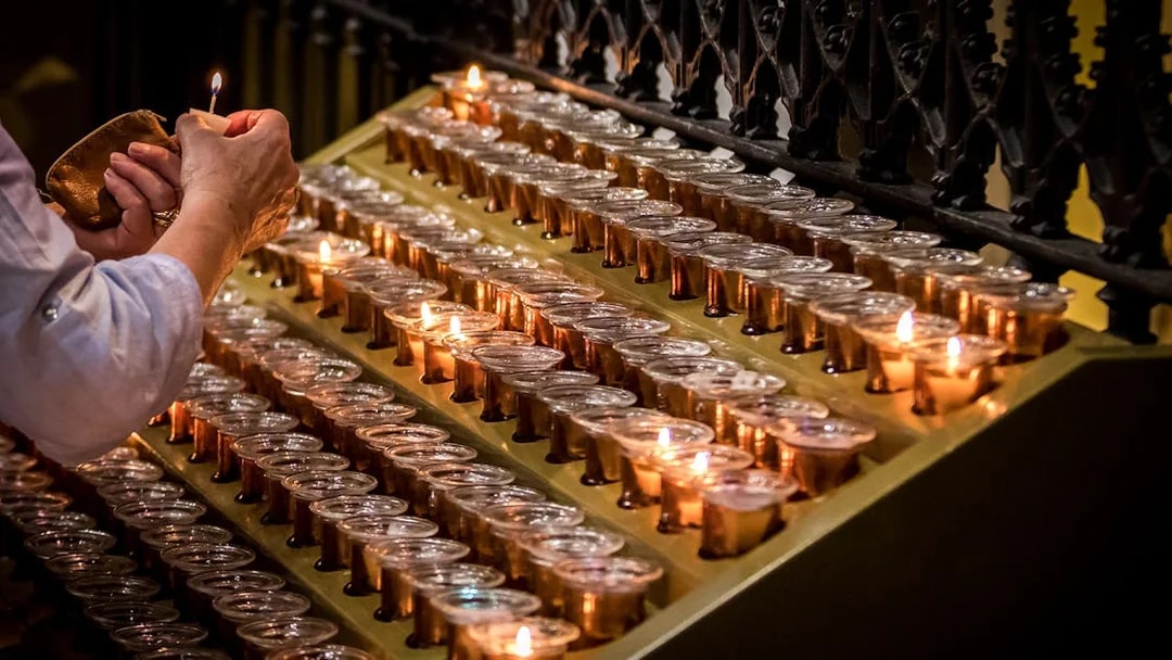 Lighting candles inside Milan Duomo during Skip-the-Line tour.