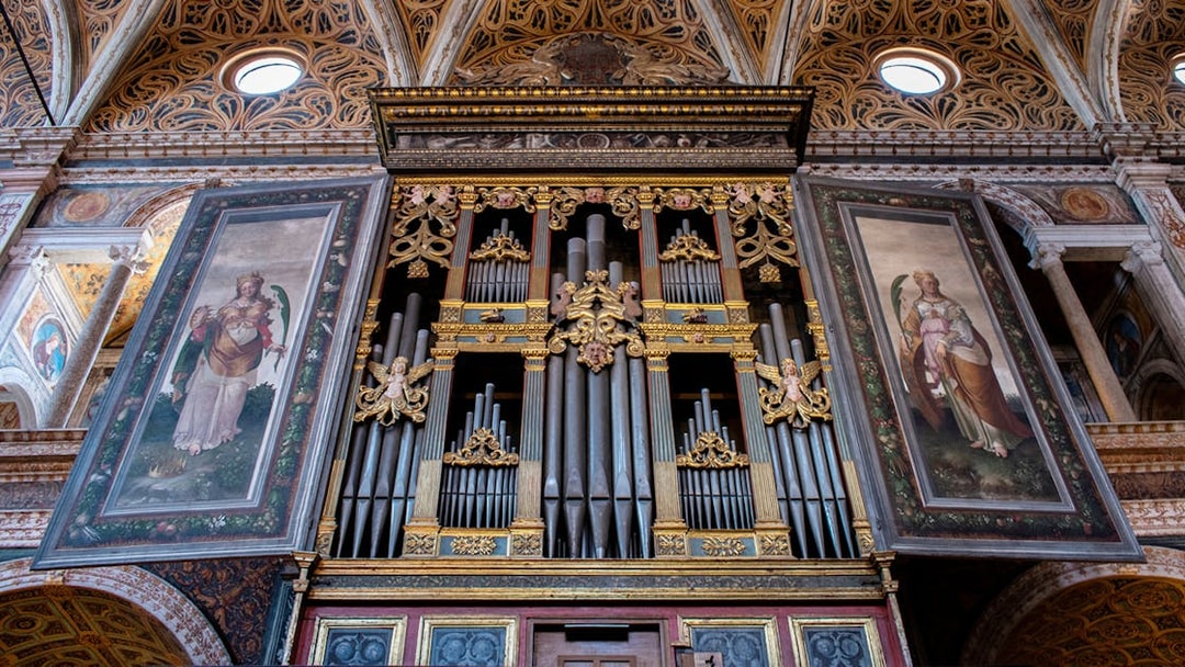 Milan Duomo Museum mechanical organ with ornate artwork panels.