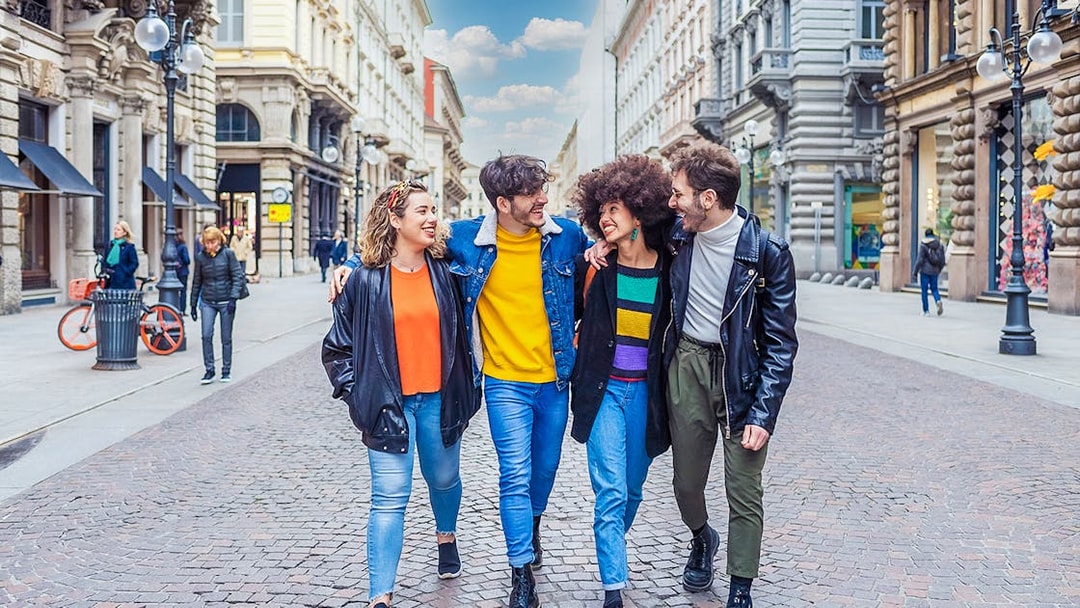 Tourists walking on a street in Milan during a city tour.