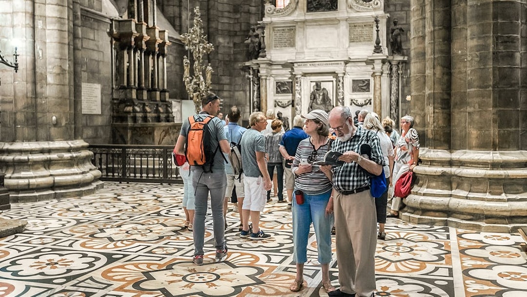 Tourists exploring the interior of Duomo Cathedral, Milan.