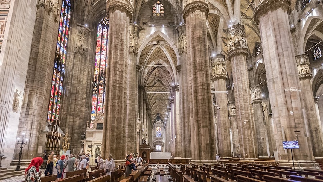 Duomo Cathedral interior in Milan with ornate columns and detailed ceiling.