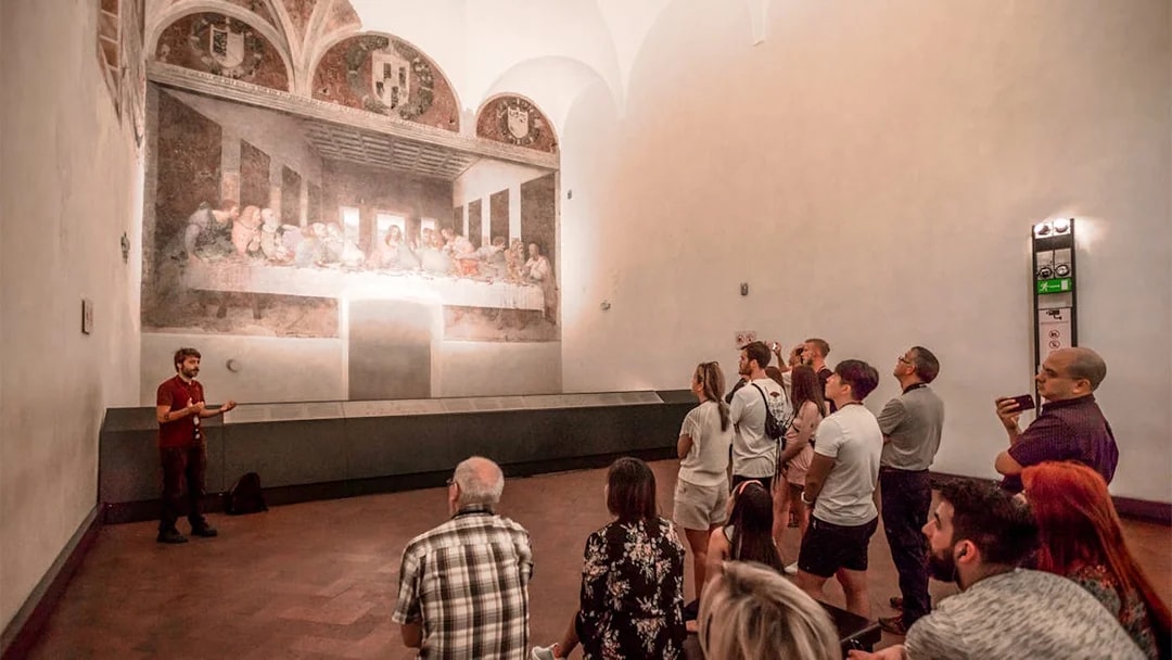 Tour group viewing The Last Supper painting in Milan's Santa Maria delle Grazie.