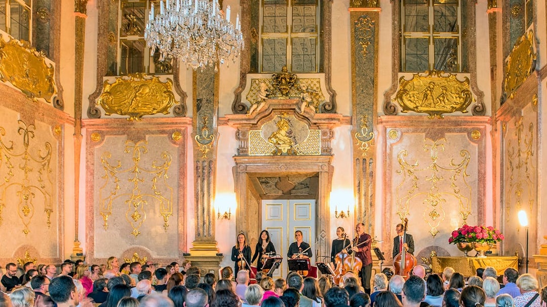 Musicians performing classical music at Mirabell Palace concert hall, Salzburg.