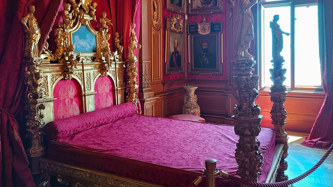 Miramare Castle bedroom with ornate bed and historical furnishings in Trieste, Italy.