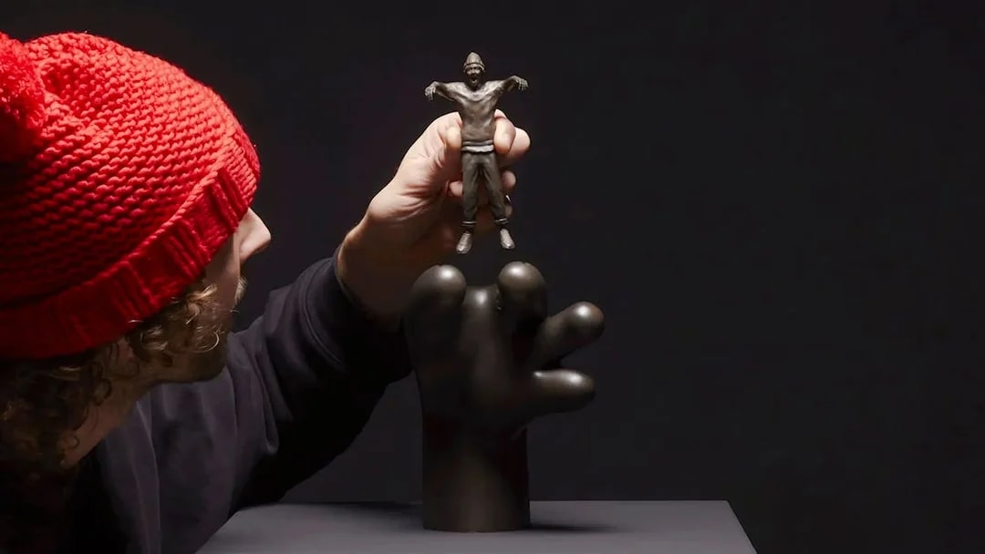 Hand holding a small sculpture by Frankey at Moco Amsterdam's Planet Positive Disruption exhibit.