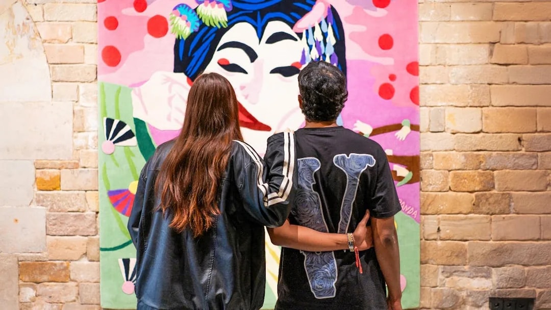 Couple viewing colorful artwork at Moco Museum, Amsterdam.