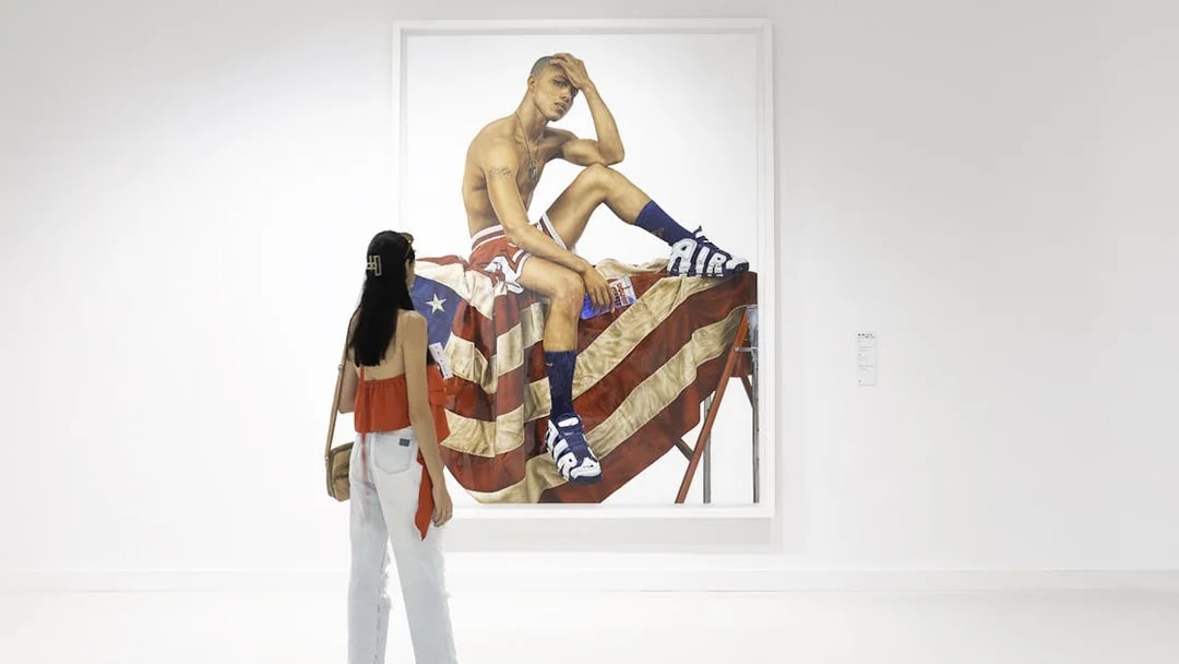 Woman viewing artwork at Moco Museum, Amsterdam.