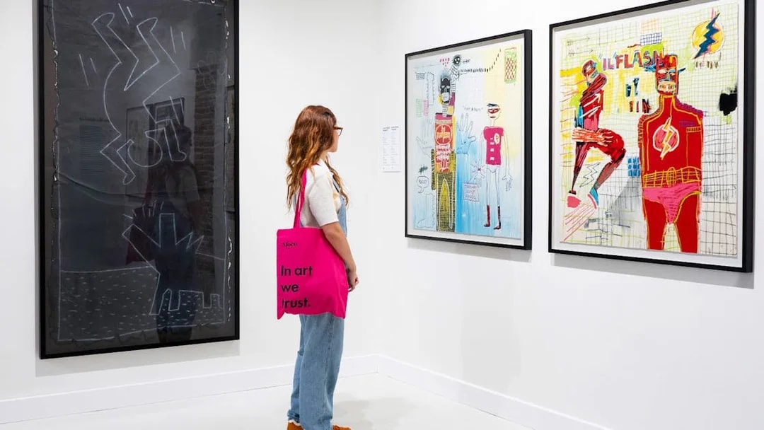 Woman viewing modern art at Moco Museum exhibition.