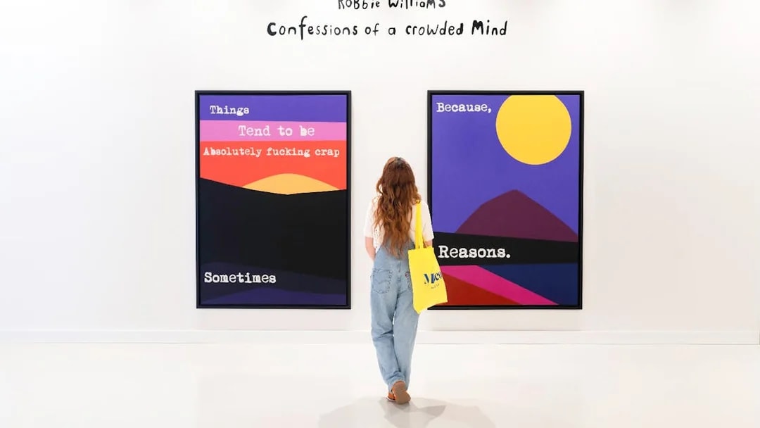 Woman viewing colorful art at Moco Museum exhibit.